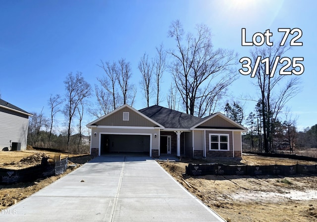 view of front of property with concrete driveway and an attached garage