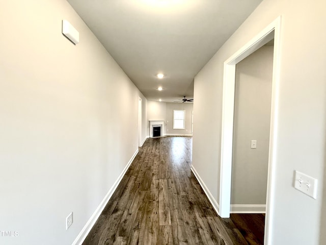 hall with dark wood finished floors and baseboards