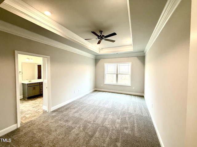 unfurnished room with light colored carpet, baseboards, a tray ceiling, and ceiling fan