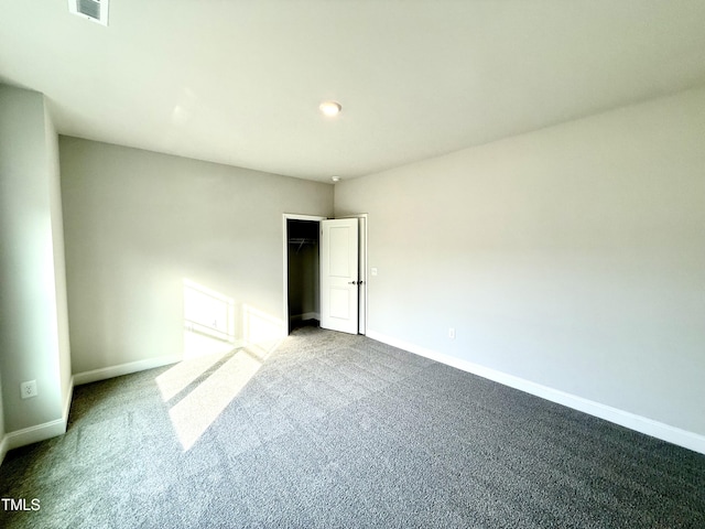 unfurnished bedroom with a closet, carpet flooring, baseboards, and visible vents