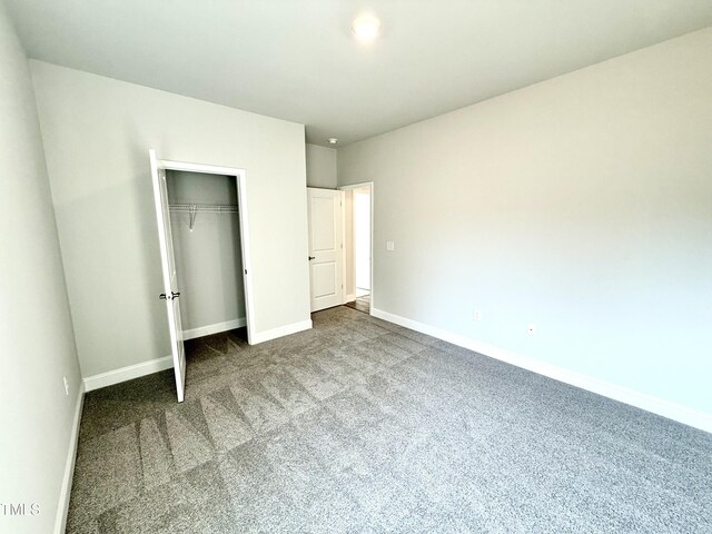 unfurnished bedroom featuring a closet, baseboards, and carpet floors