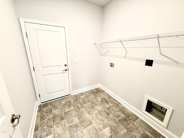 laundry area with baseboards, washer hookup, and laundry area