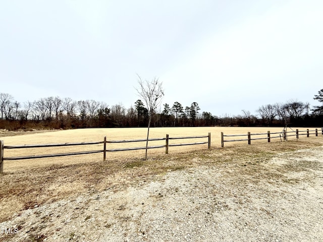 view of yard with a rural view and fence