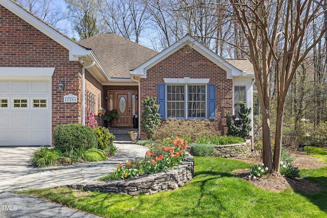 view of front of property with a garage and a front yard