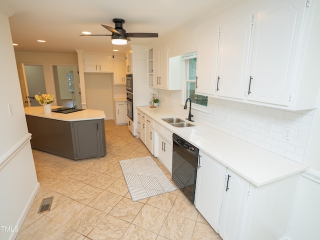 kitchen featuring black appliances, tasteful backsplash, white cabinetry, sink, and ceiling fan