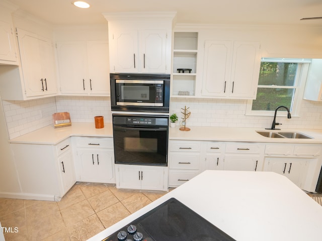 kitchen with white cabinetry, sink, and oven