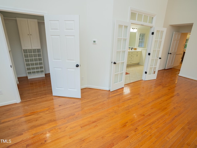 unfurnished room with light hardwood / wood-style floors and french doors