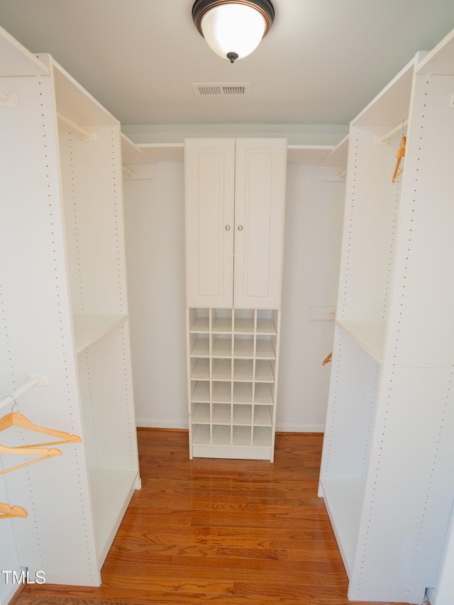 walk in closet featuring light hardwood / wood-style floors