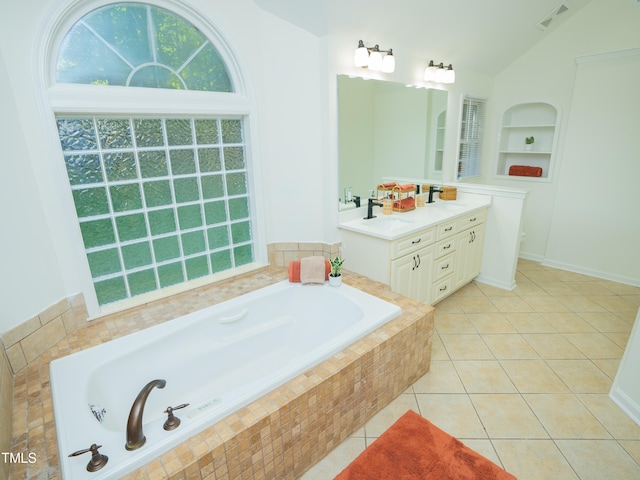 bathroom with lofted ceiling, vanity, tile patterned floors, and a relaxing tiled tub