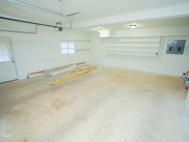 garage with a garage door opener and electric panel