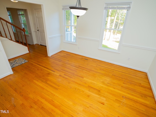 unfurnished dining area with light wood-type flooring