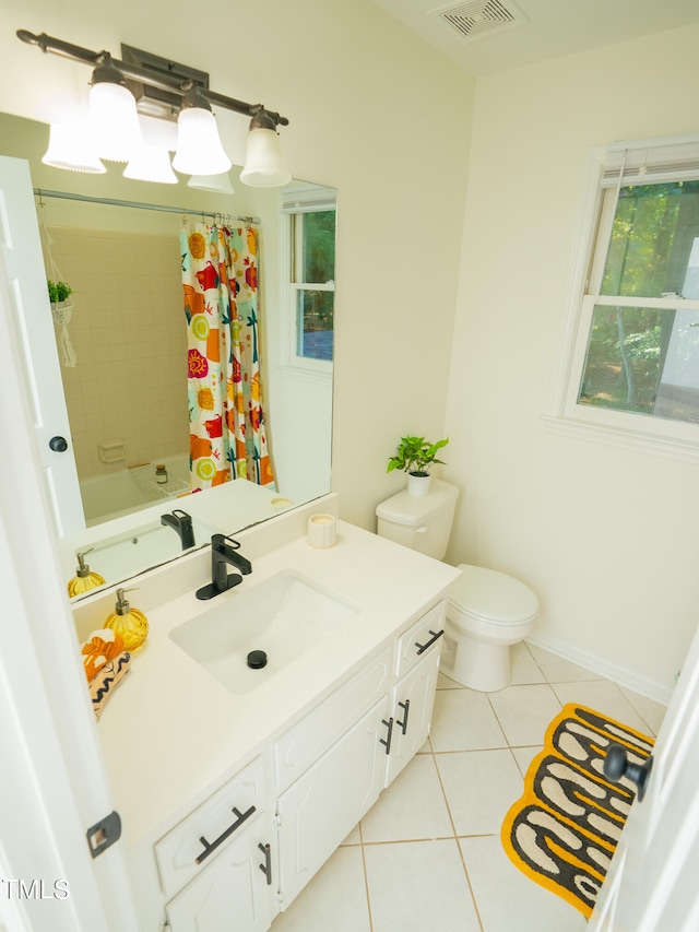 full bathroom with toilet, vanity, tile patterned flooring, and shower / bath combo with shower curtain