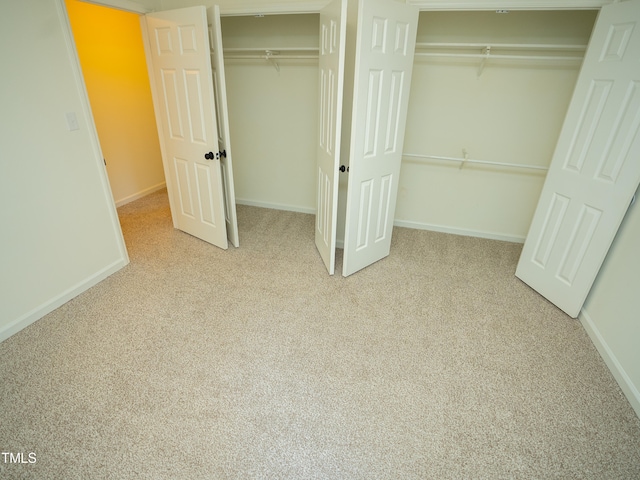 unfurnished bedroom featuring light carpet