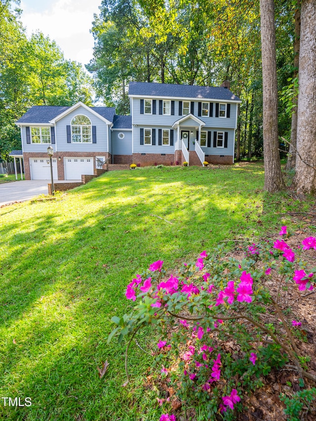 view of front of home featuring a garage and a front yard