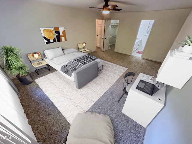 carpeted bedroom with ensuite bathroom, ceiling fan, and a walk in closet