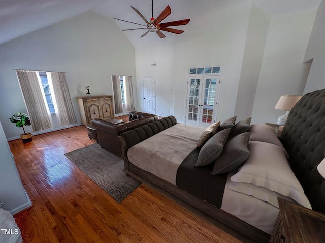 bedroom with high vaulted ceiling, wood-type flooring, ceiling fan, and french doors