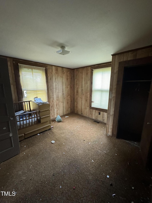 bedroom with wood walls