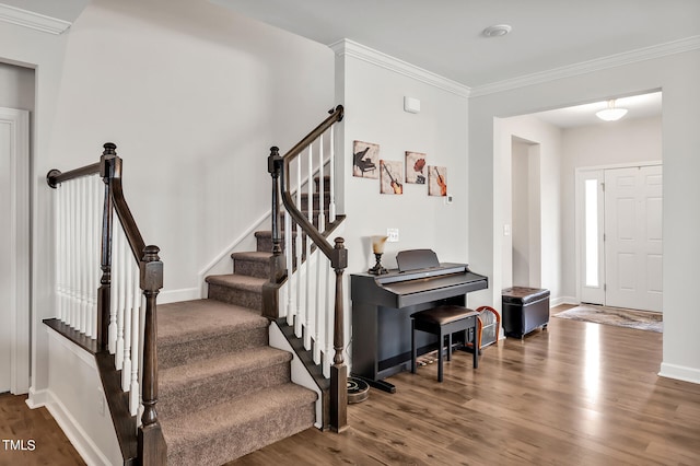 foyer with crown molding and hardwood / wood-style floors