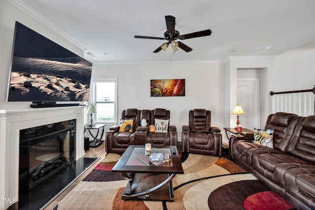 living room featuring ornamental molding, wood-type flooring, and ceiling fan