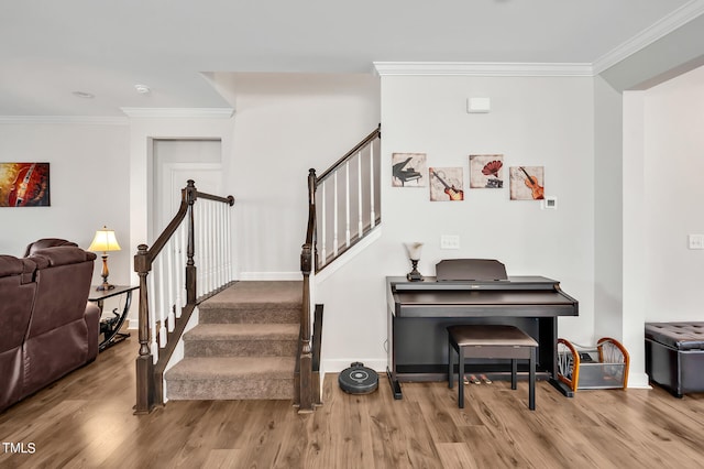 stairway featuring crown molding and hardwood / wood-style flooring