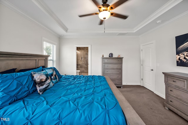 carpeted bedroom with a tray ceiling, ceiling fan, ensuite bath, and crown molding