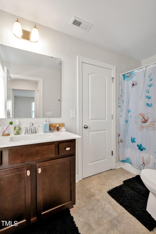 bathroom featuring vanity, toilet, and a shower with curtain