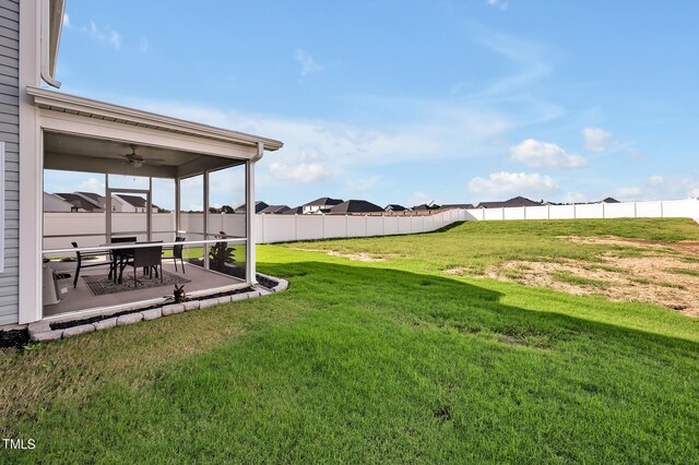 view of yard with ceiling fan and a patio