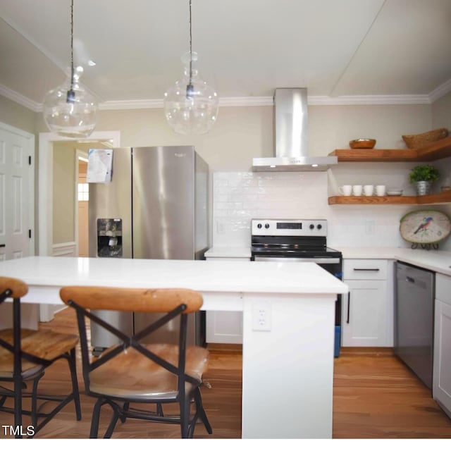 kitchen featuring a kitchen bar, hanging light fixtures, decorative backsplash, exhaust hood, and stainless steel dishwasher