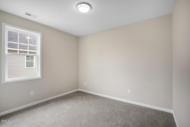 carpeted spare room with baseboards