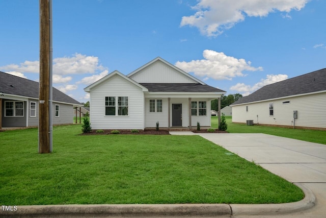 view of front facade with a front yard, central AC unit, and a porch