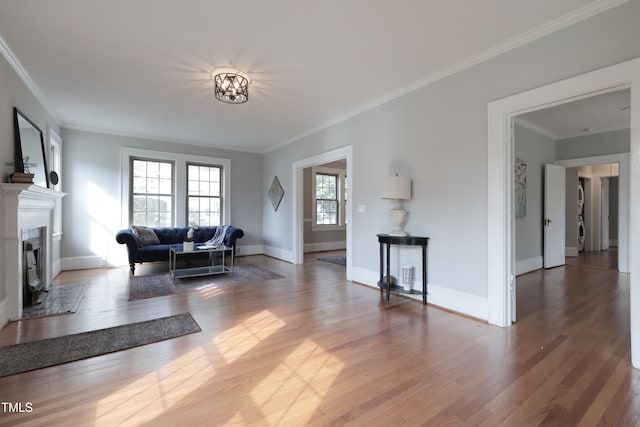 living room featuring ornamental molding, hardwood / wood-style floors, and a healthy amount of sunlight