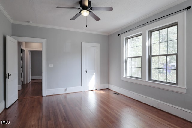 unfurnished bedroom featuring ceiling fan, a textured ceiling, ornamental molding, and dark hardwood / wood-style flooring