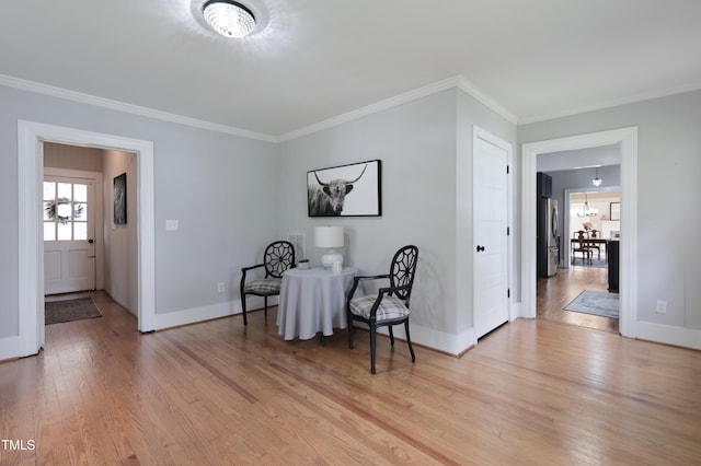 sitting room featuring light hardwood / wood-style floors and ornamental molding