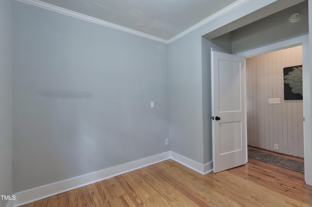 spare room with light hardwood / wood-style flooring and crown molding