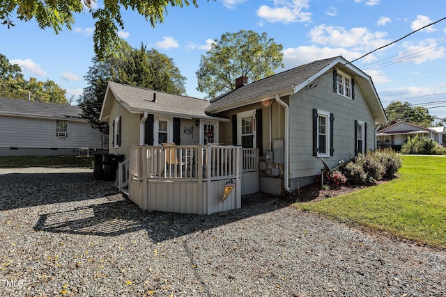 view of front facade with a front yard and a deck