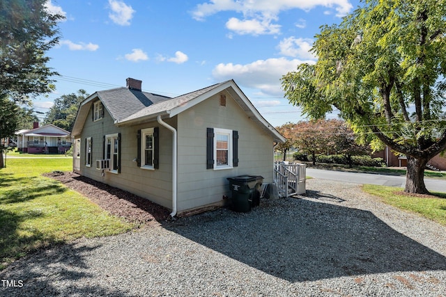 view of side of property with a yard