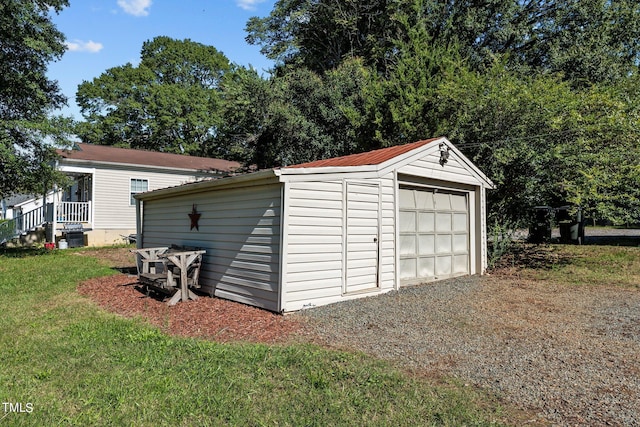 view of outdoor structure featuring a lawn and a garage