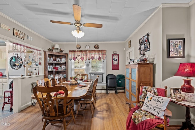 dining area featuring ceiling fan, stacked washer / dryer, light hardwood / wood-style floors, and crown molding