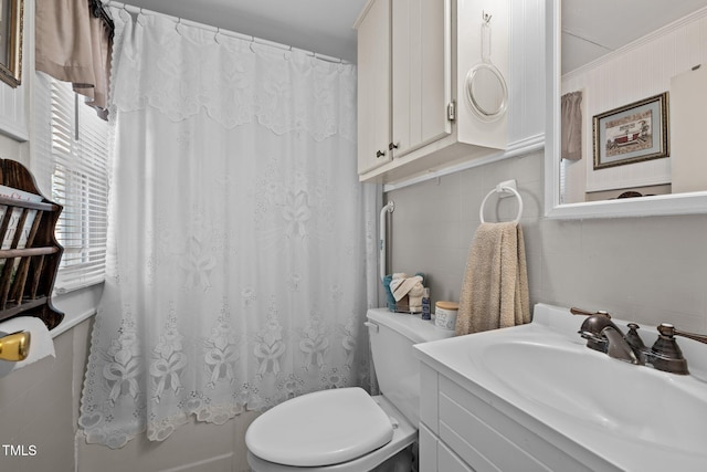 bathroom with vanity, toilet, and curtained shower