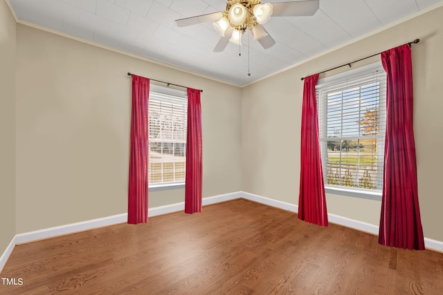 unfurnished room with hardwood / wood-style flooring, crown molding, and ceiling fan