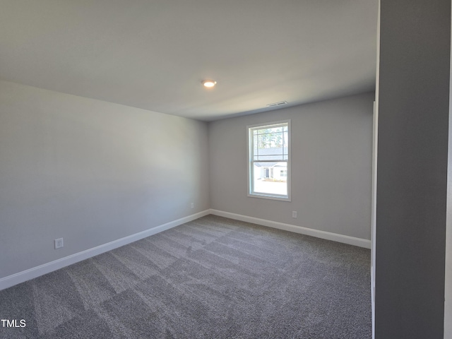 unfurnished room with carpet, baseboards, and visible vents