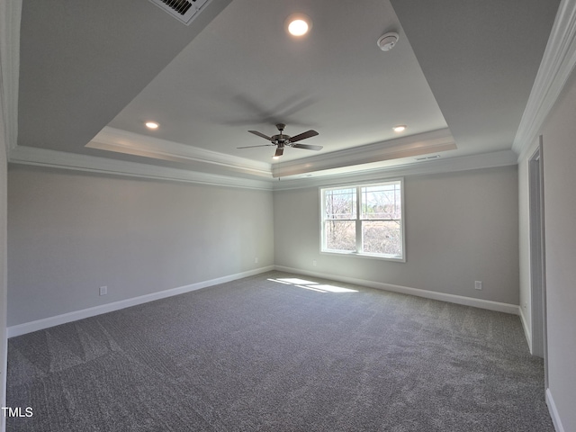 carpeted spare room featuring a tray ceiling, crown molding, recessed lighting, visible vents, and baseboards