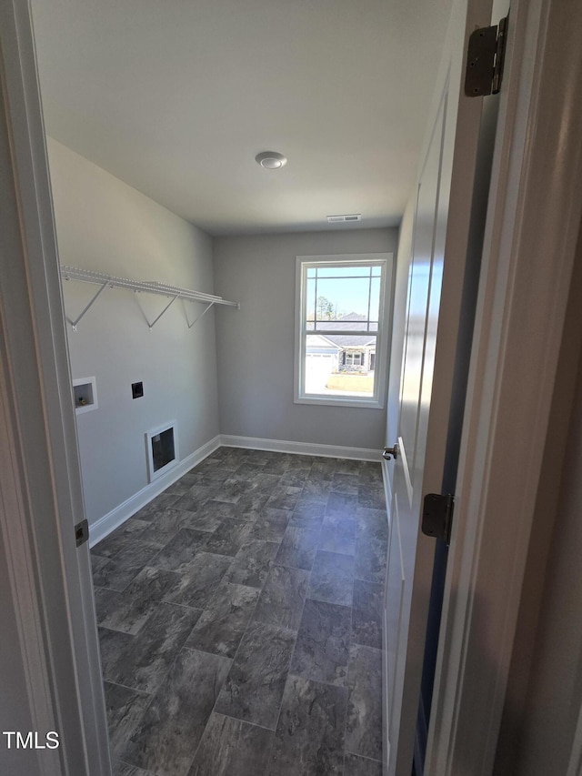 laundry area featuring laundry area, baseboards, visible vents, stone finish floor, and washer hookup