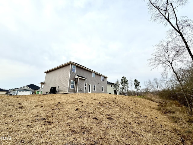 rear view of house with cooling unit