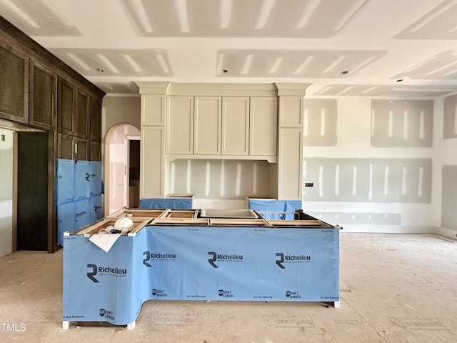 7000 N Ridge Dr, Raleigh, NC 27615 - kitchen featuring arched walkways and dark brown cabinetry