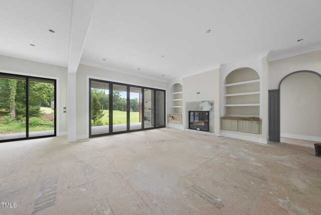 7000 N Ridge Dr, Raleigh, NC 27615 - unfurnished living room featuring built in features, a glass covered fireplace, and crown molding