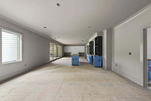 7000 N Ridge Dr, Raleigh, NC 27615 - unfurnished living room featuring healthy amount of natural light and crown molding