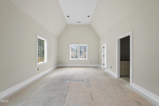7000 N Ridge Dr, Raleigh, NC 27615 - spare room with vaulted ceiling and baseboards