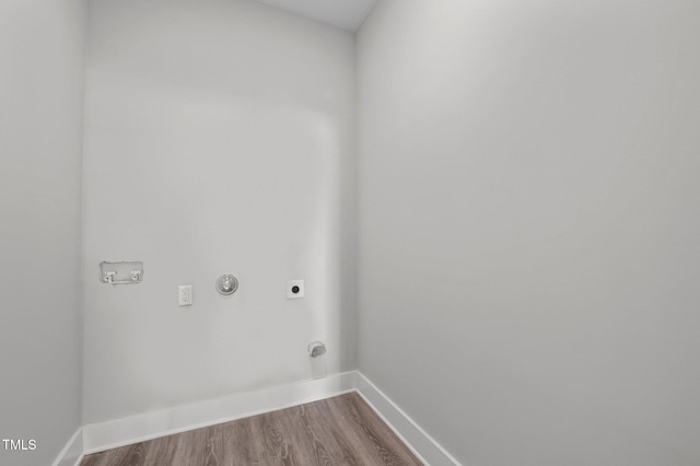 washroom featuring laundry area, electric dryer hookup, baseboards, and wood finished floors