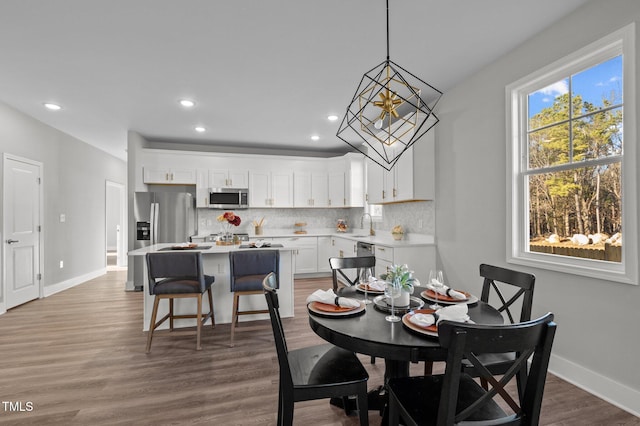 dining area with recessed lighting, wood finished floors, and baseboards